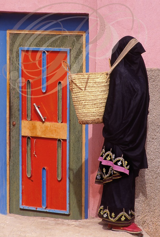 AGARD OUDAD - Femme en amlhaf devant une porte peinte