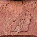 COLLONGES-LA-ROUGE - linteau de porte en grès rouge sculpté représentant un pélerin sur le chemin de Saint-Jacques de Compostelle