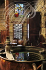 Distillerie DENOIX à Brive-la-Gaillarde (19) - reflet du vitrail dans la cuve au serpentin 