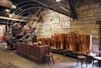 Distillerie DENOIX à Brive-la-Gaillarde (19) - la salle de l'alambic : foudres de vieillissement en chêne et cuves de macération en cuivre